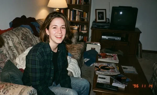 Young woman smiling in a living room in the 1990s