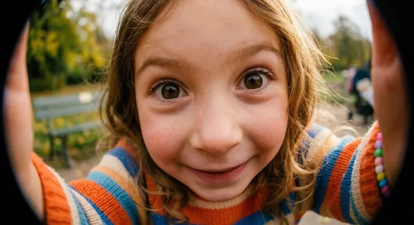 Child looking at the camera with a big smile